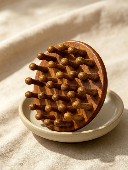 Round Head Massage Comb on ceramic dish
