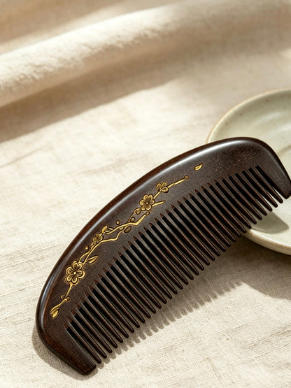 Plum Blossom Crescent Comb on fabric with ceramic dish