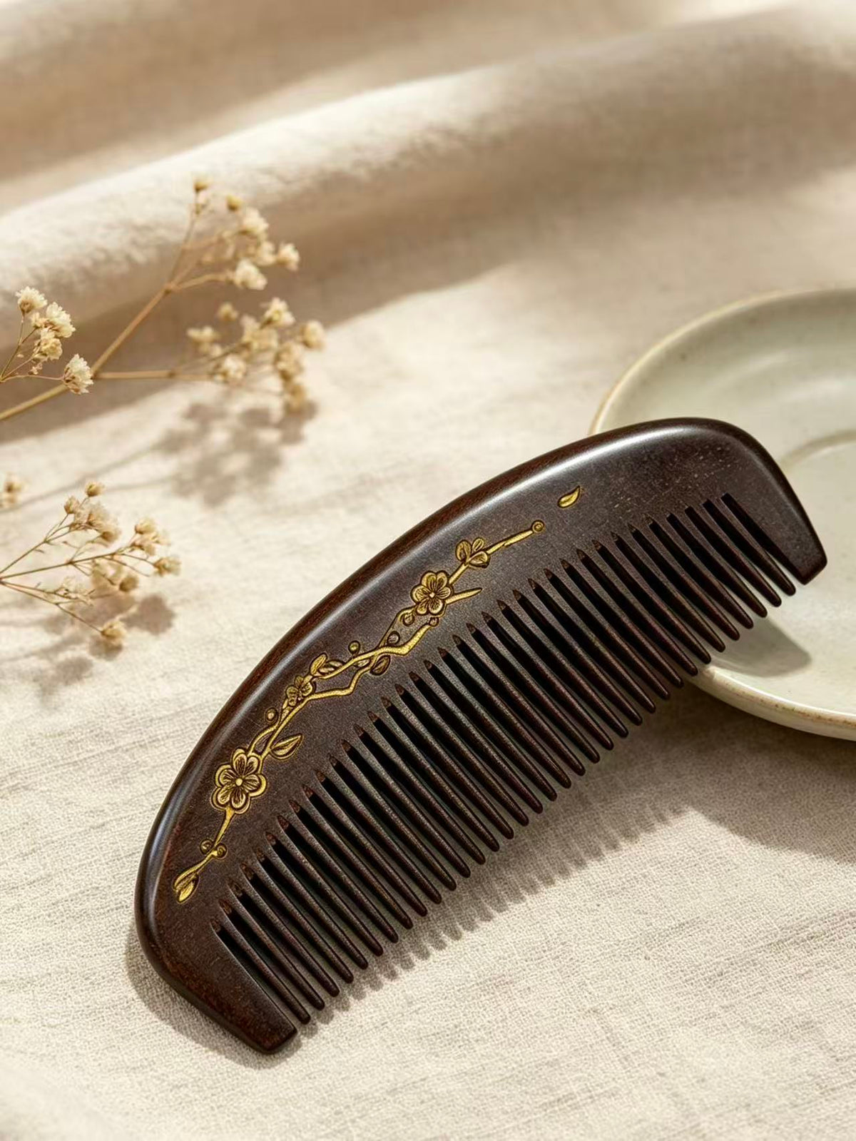 Plum Blossom Crescent Comb angled view on fabric